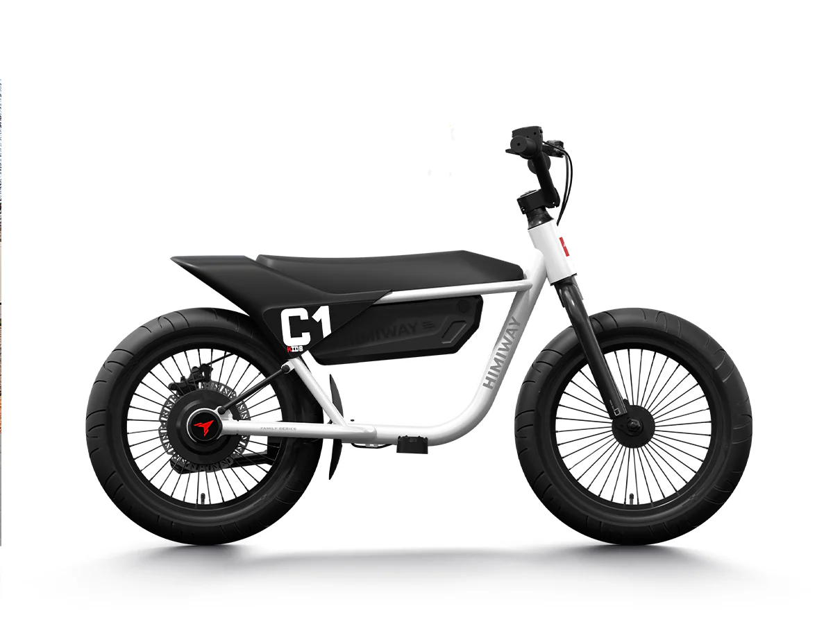 alt="Child joyfully riding the Himiway C1 Kids Electric Bike through a park, showcasing its vibrant design and outdoor adventure capabilities."